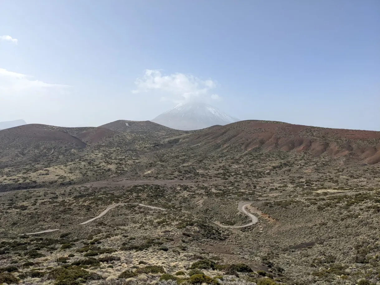 Red lava flows and winding road crossing the volcanic plateau