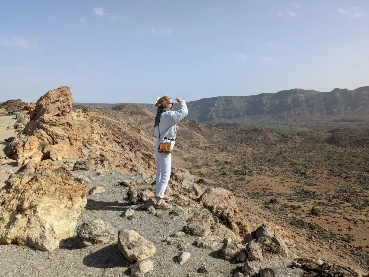 Woman hiker standing on a pile of ochre rocks