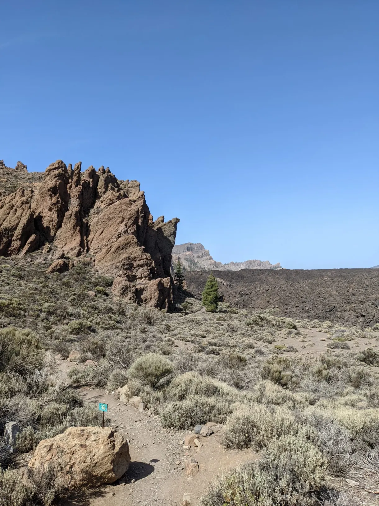 Jagged ochre rocks at the start of a trail
