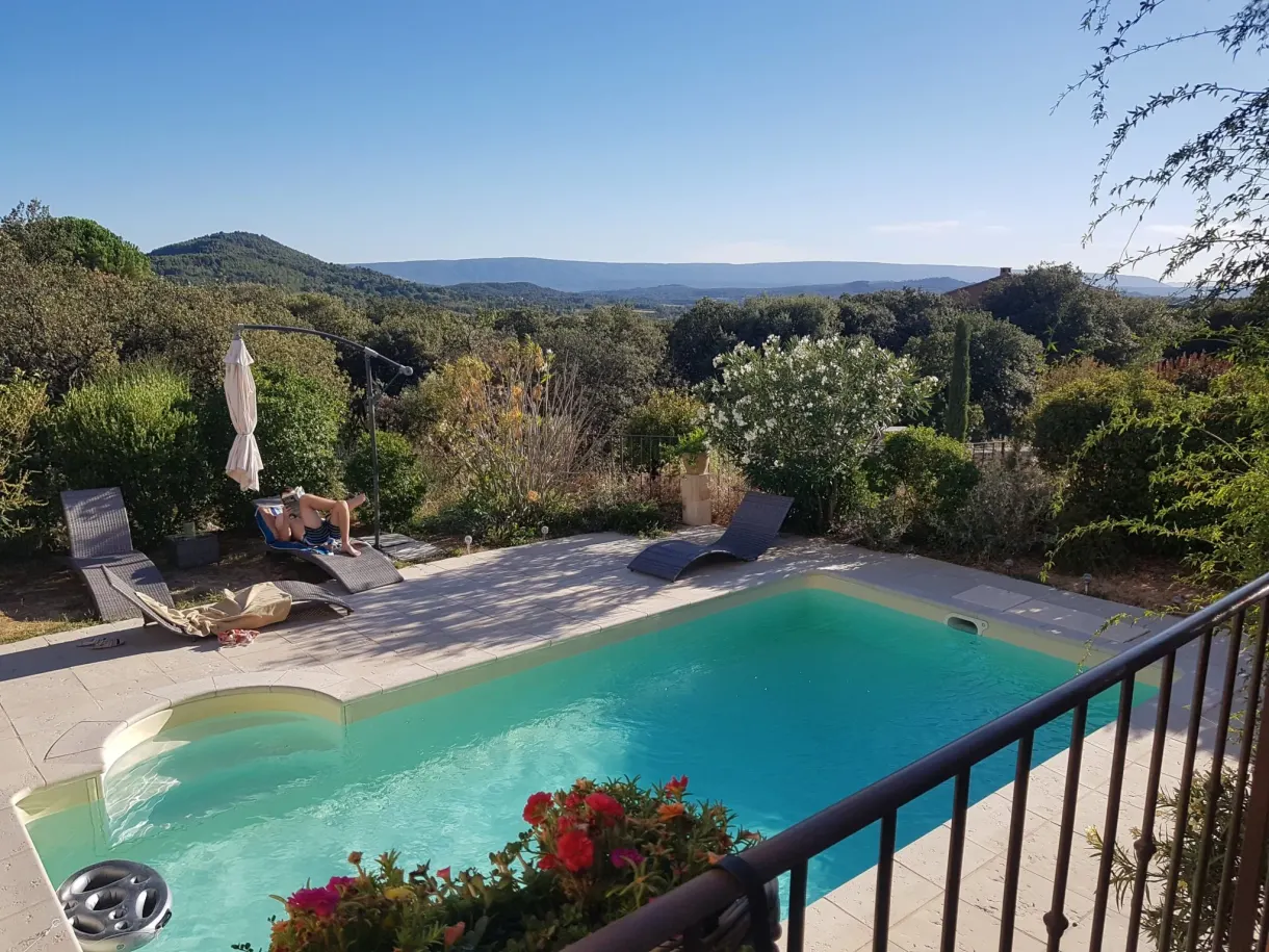 Pool and sun loungers overlooking the hills from the terrace