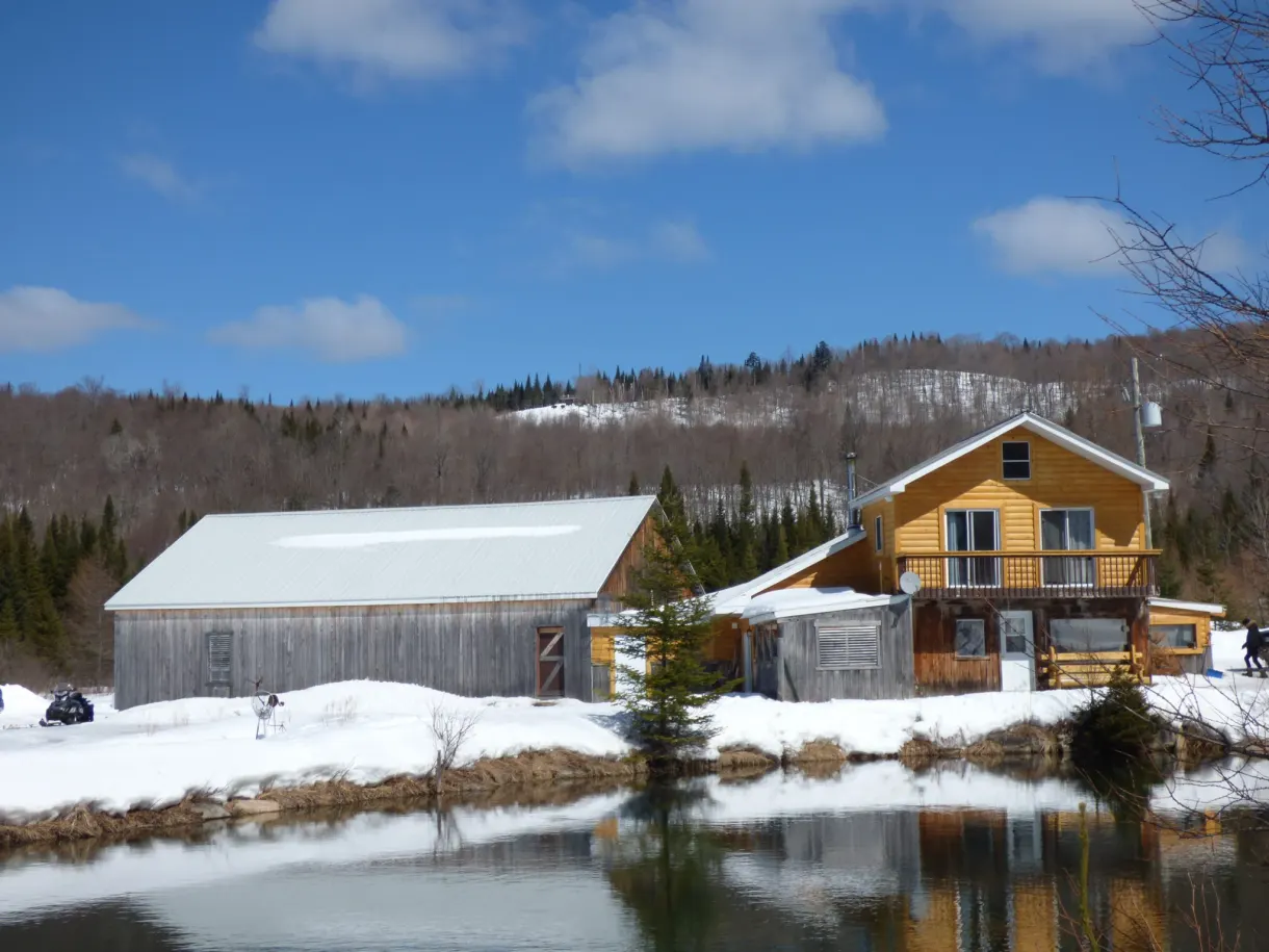 Chalet de bois et vieille grange au bord de l'étang