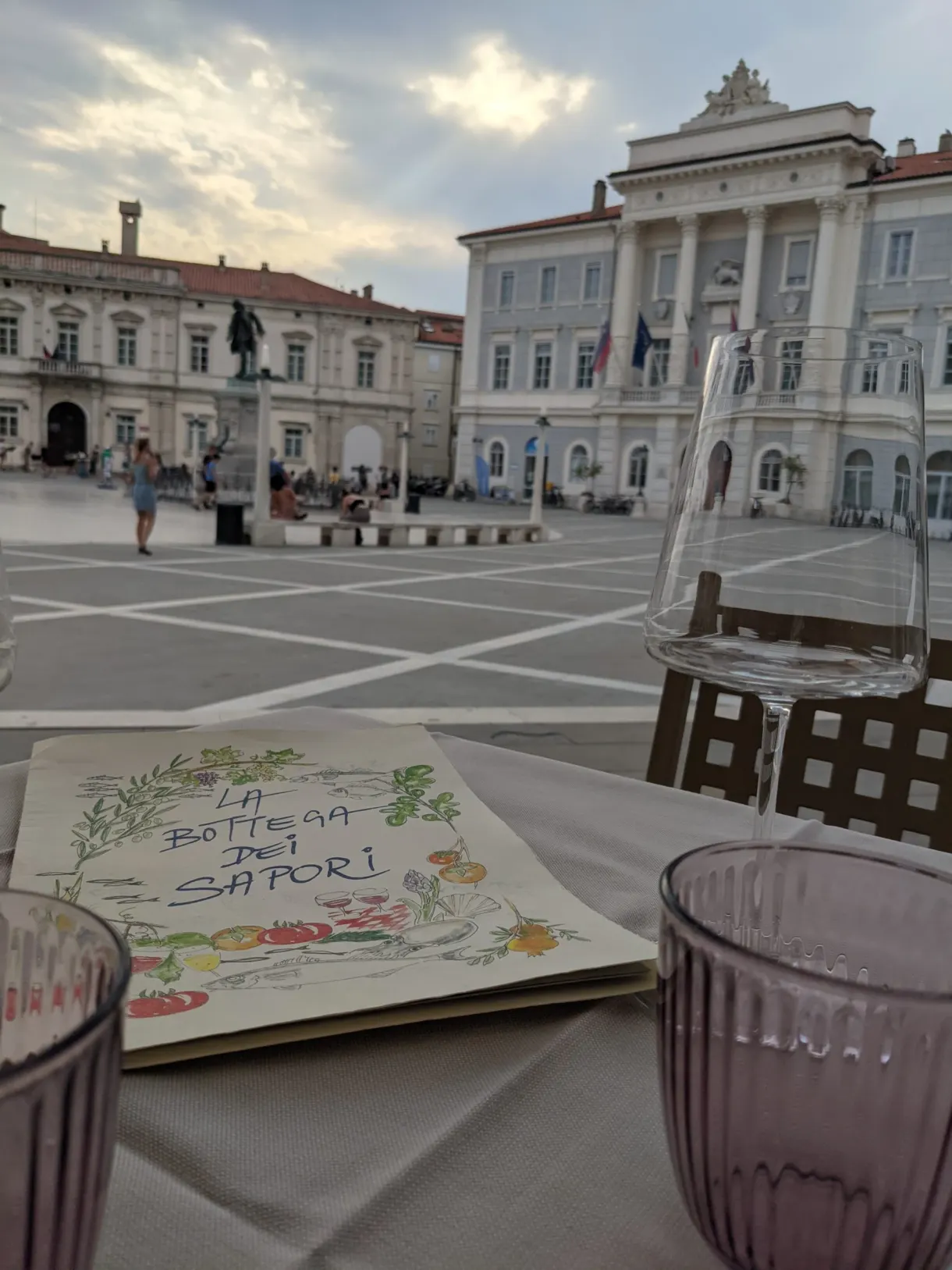 Menu illustré sur une table dressée face à la place
