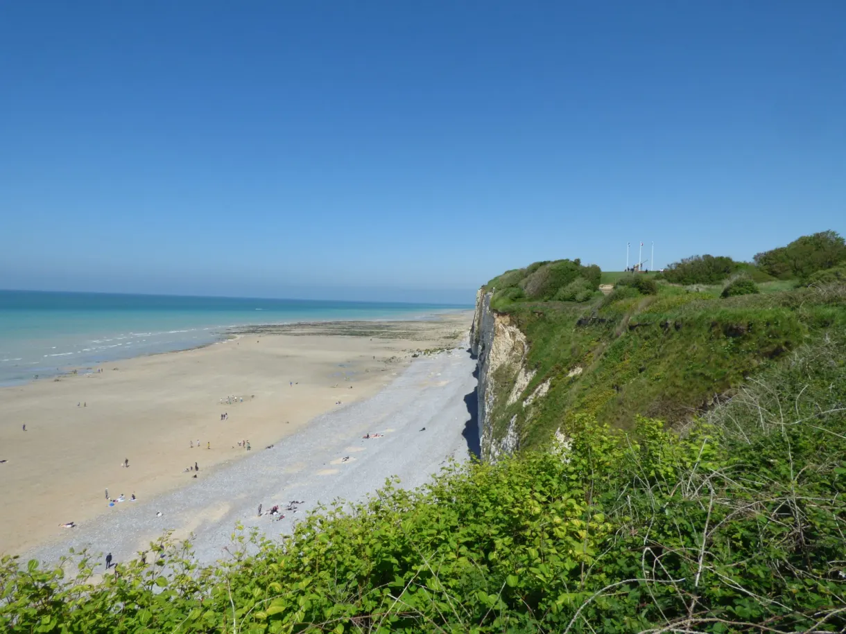 Grande plage de sable vue du sommet de la falaise verdoyante
