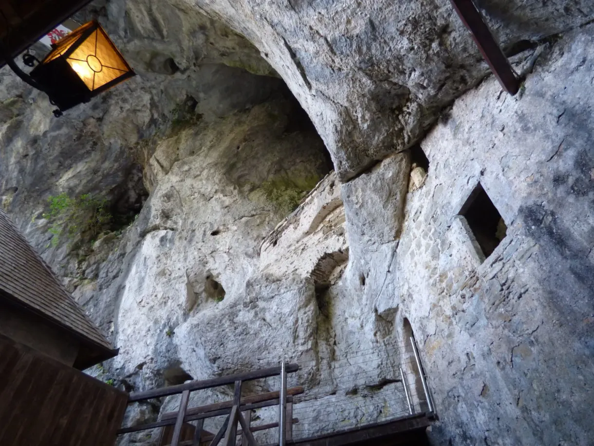 Inner cave lit by a lantern above a wooden walkway