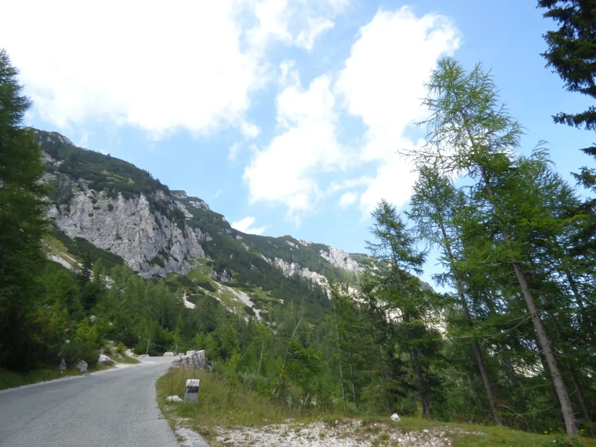 Route sinueuse au pied d'une haute paroi calcaire