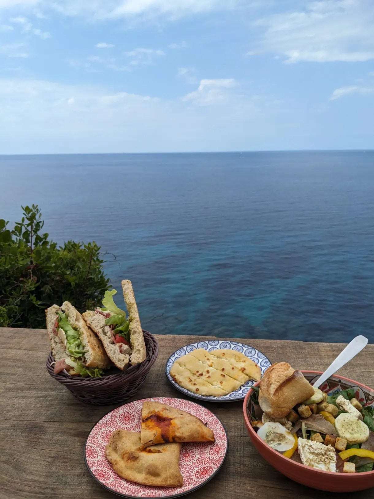 Beignets et légumes marinés sur une table au-dessus de la mer