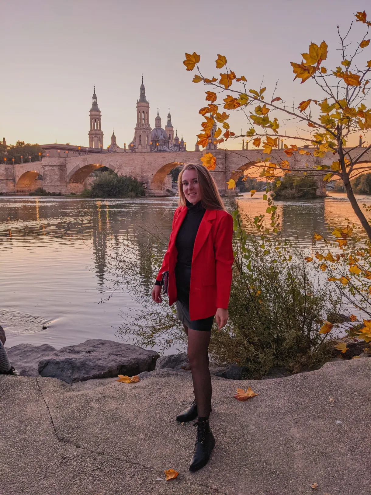 Femme en veste rouge au bord de l'Èbre en automne