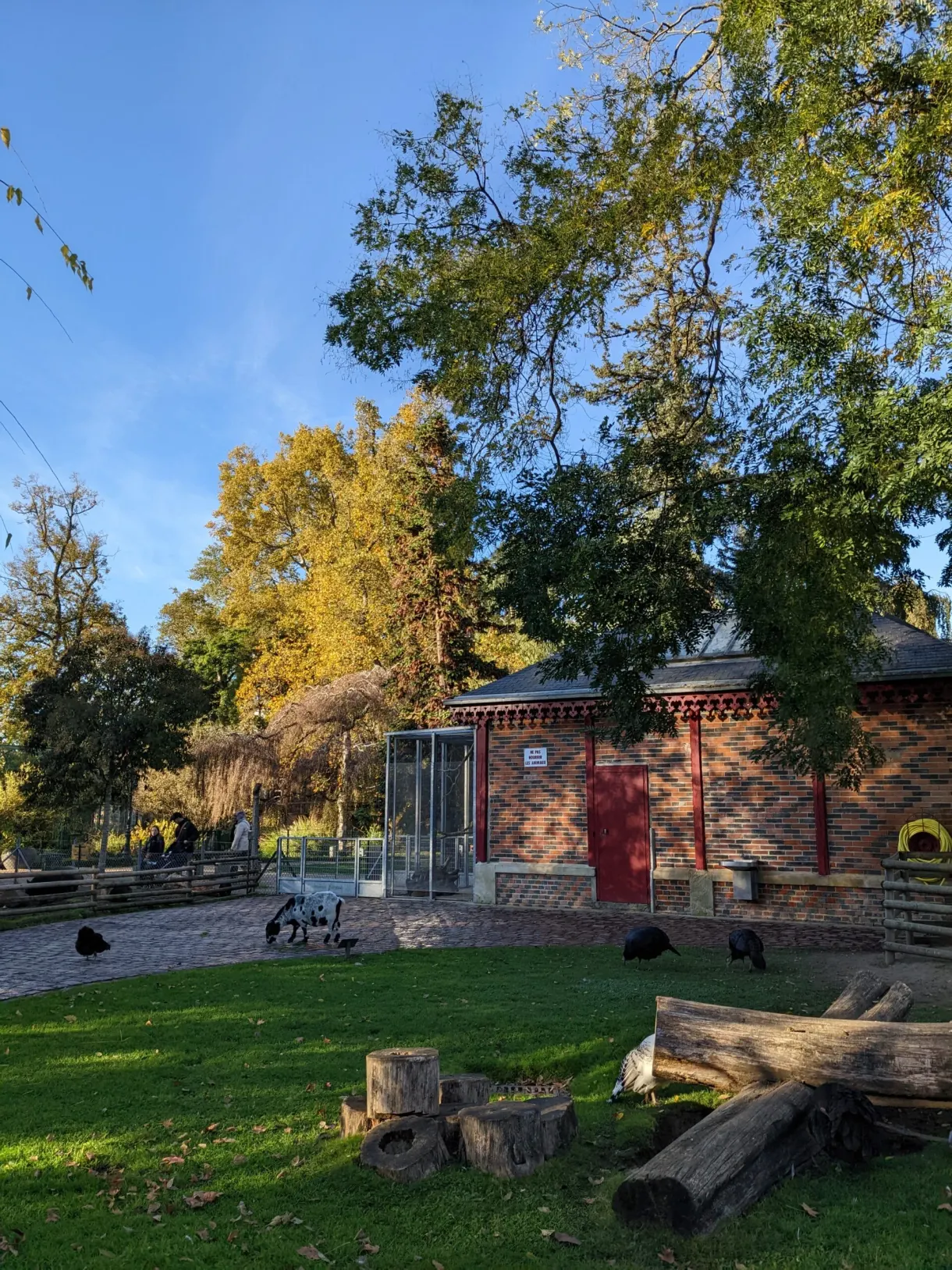 Pavillon de brique et enclos aux animaux sur la pelouse