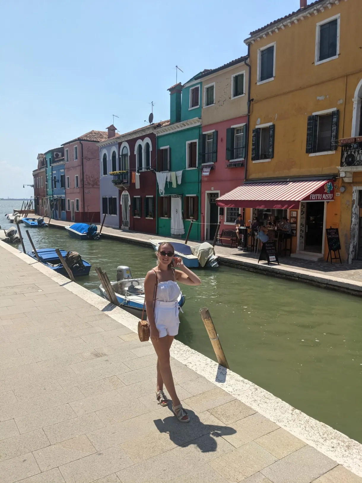 Stroller on the quay in front of the colourful houses of Burano