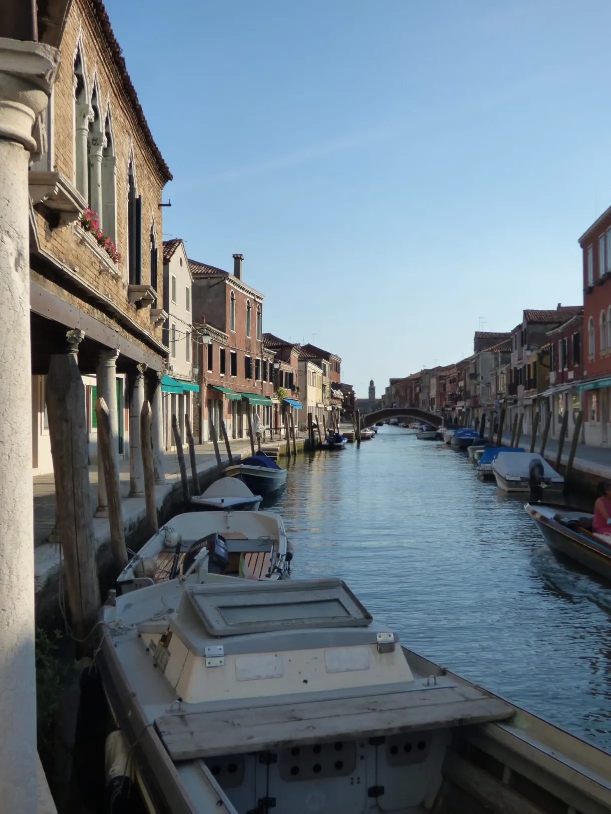 Covered boats moored along a narrow canal