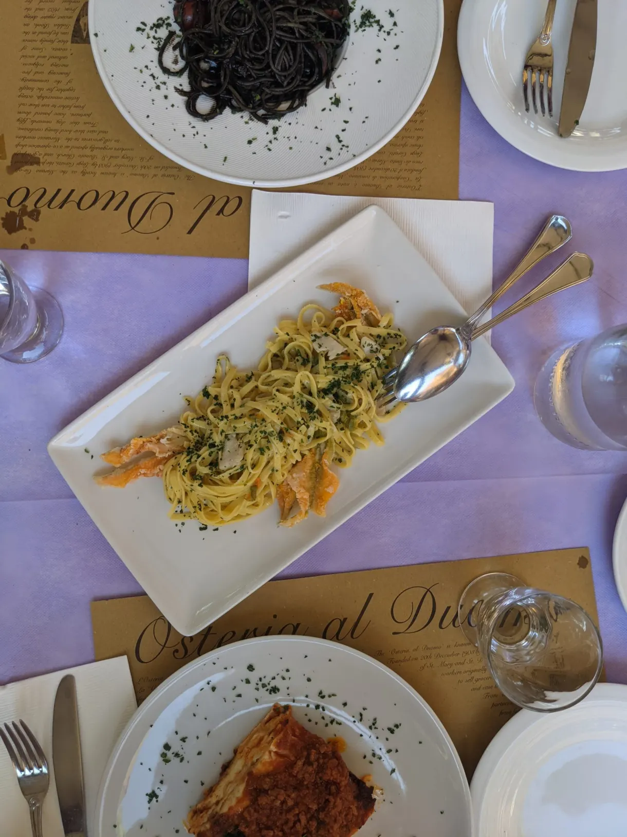 Squid ink spaghetti and fish pasta served at the table