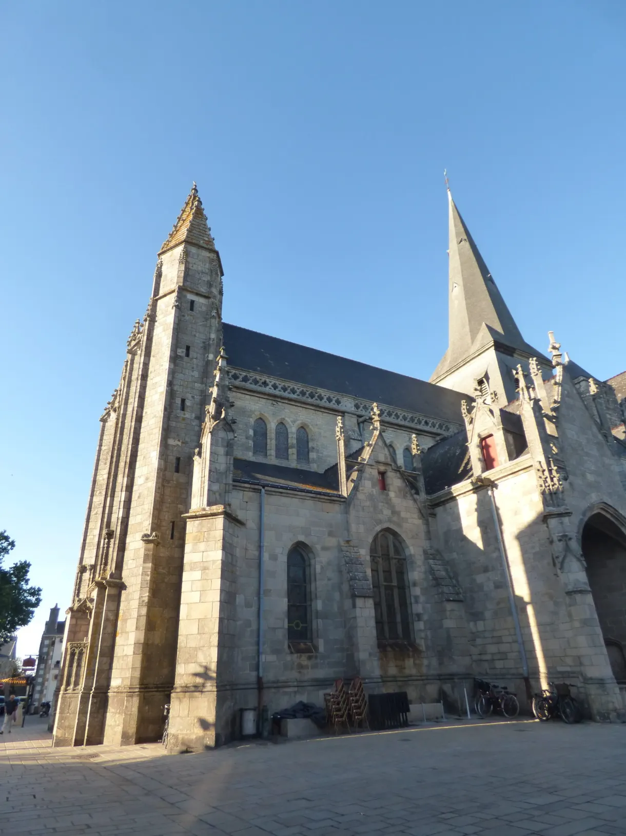 Gothic chevet of the collegiate church under a bright blue sky