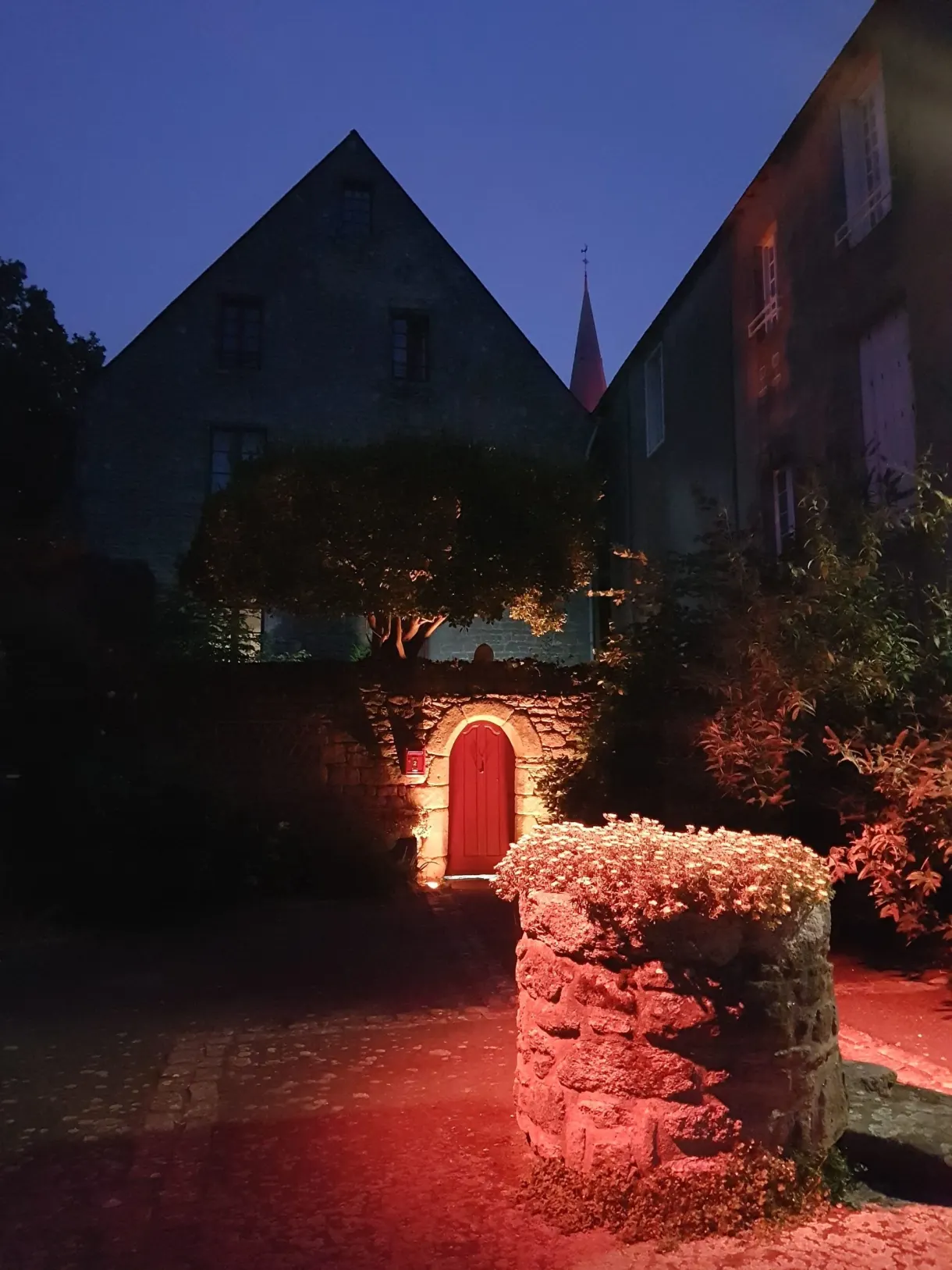 Stone well lit in red after nightfall