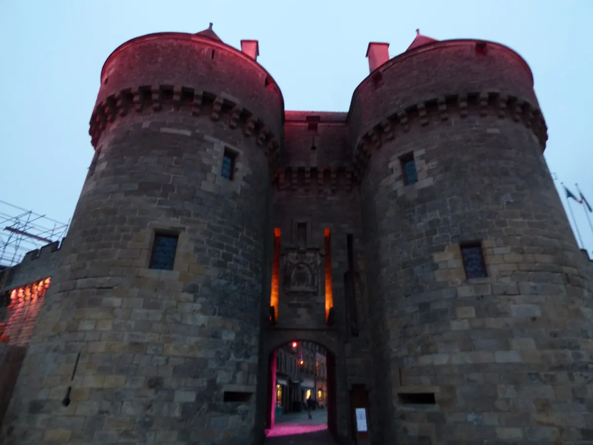 Twin towers of the fortified gate lit up in red