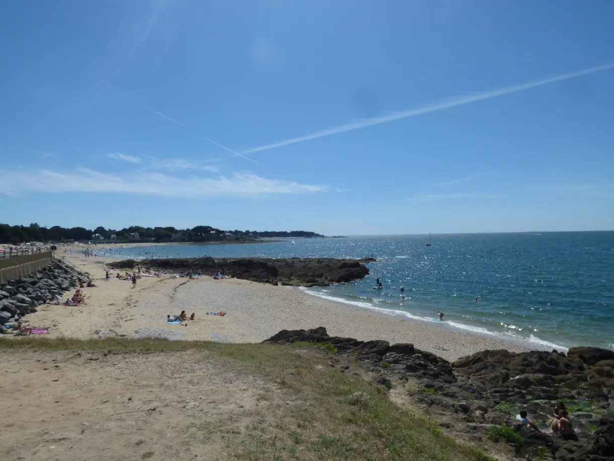 Small beach sheltered by a breakwater of rocks